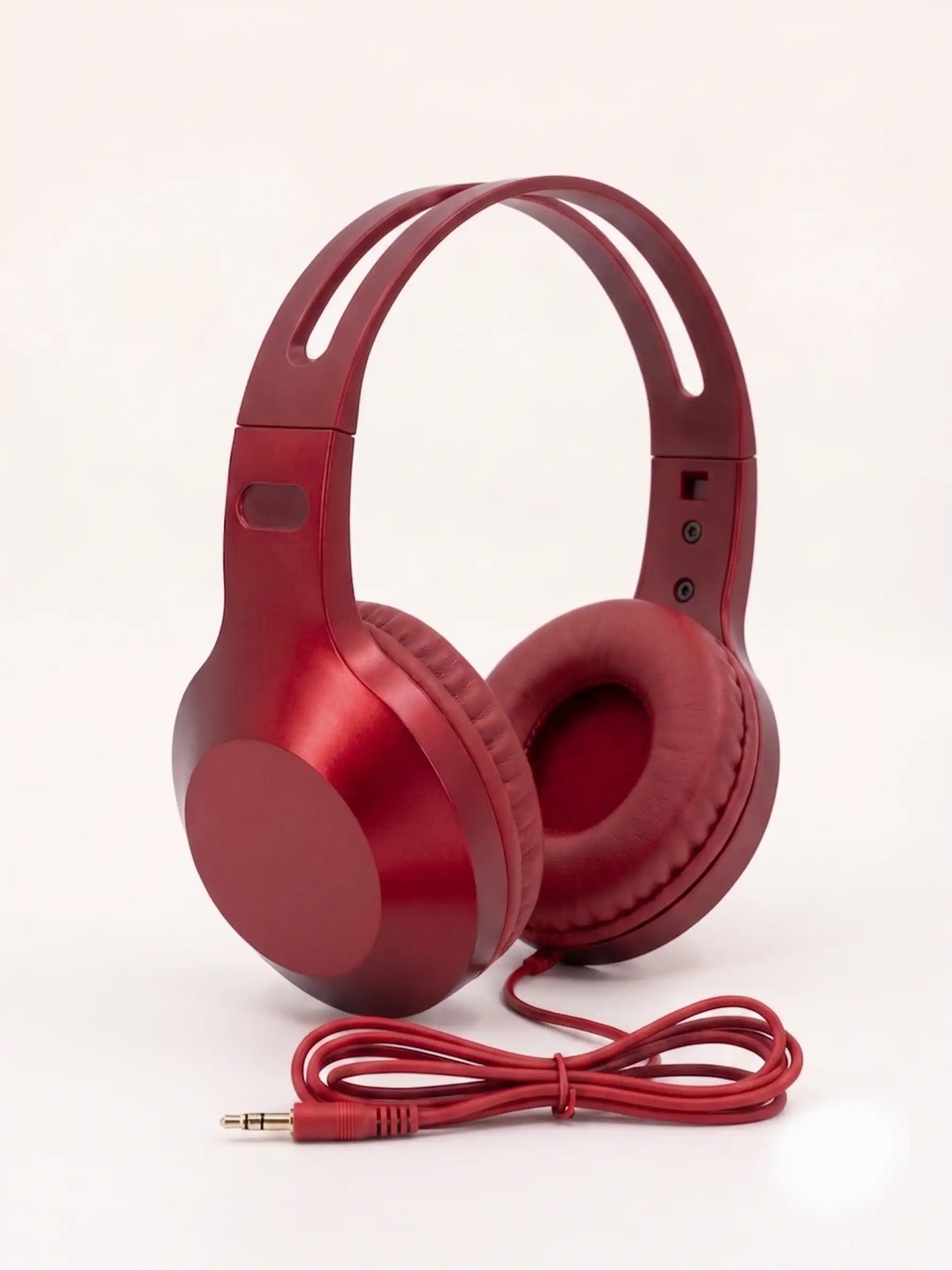 Red headphones with a cable on a white background