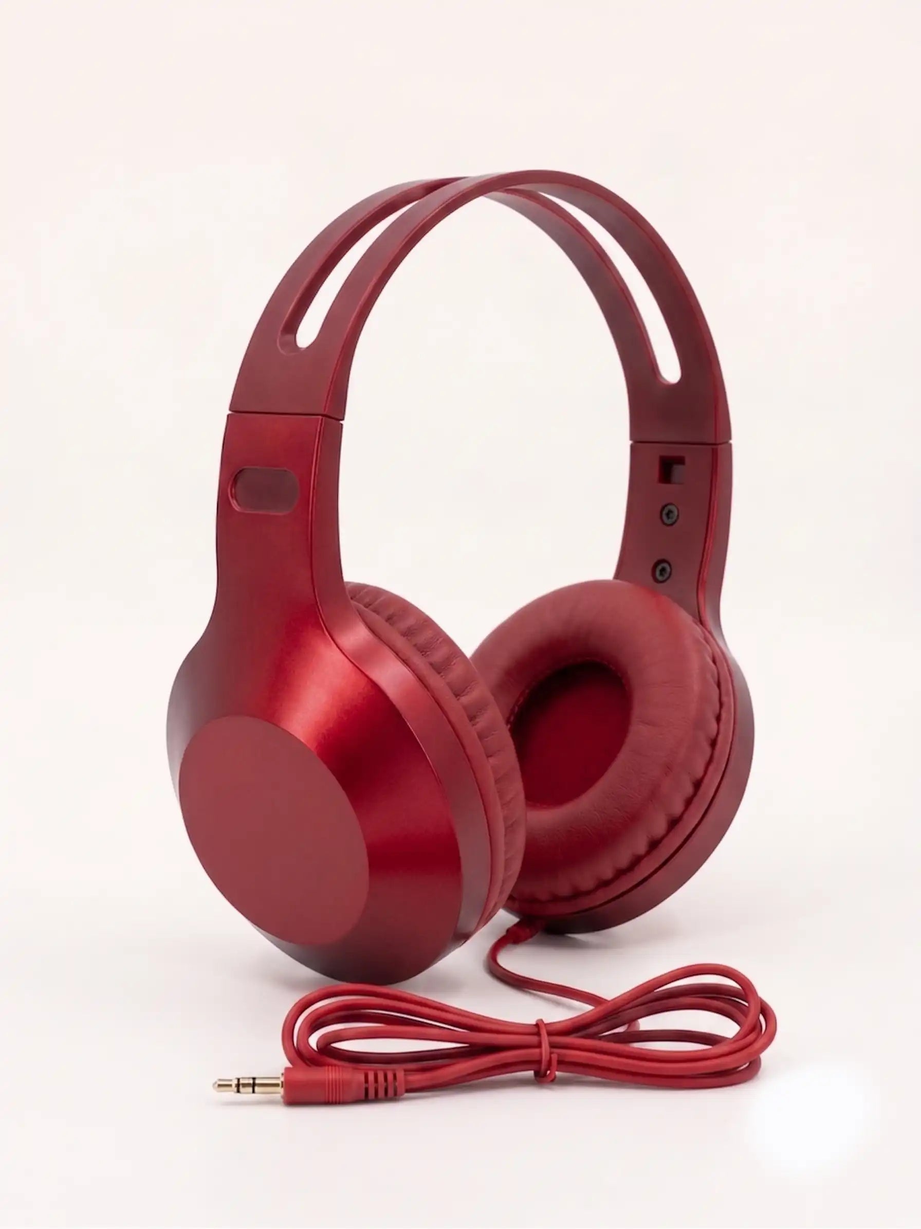 Red headphones with a cable on a white background